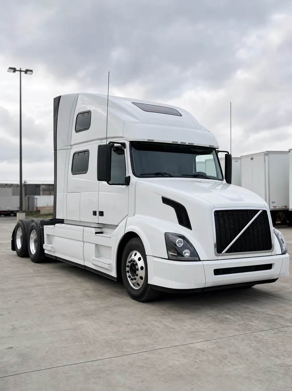 White 2016 Volvo VNL 780 sleeper tractor, three-quarter front view